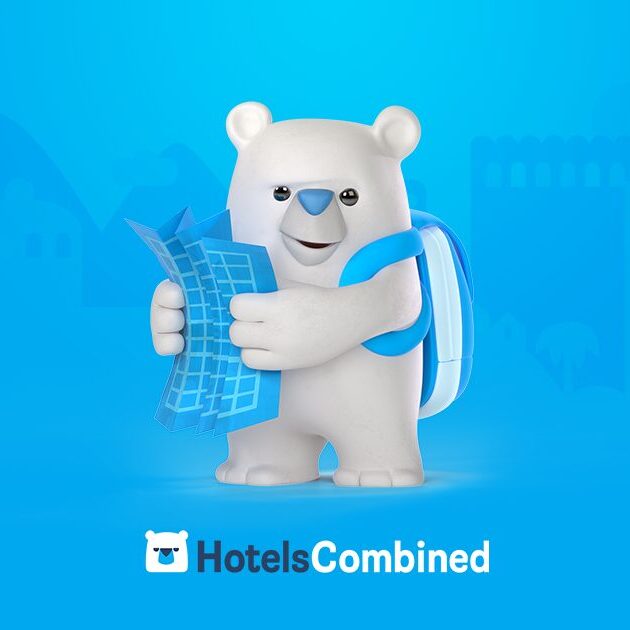 A white bear holding a blue towel in his hands.